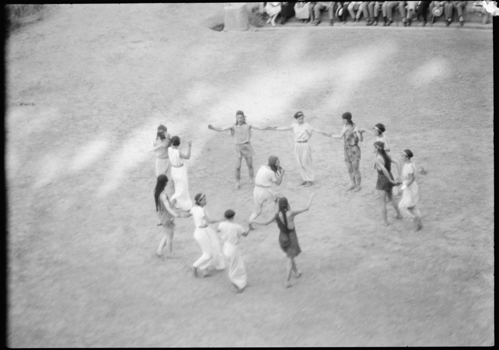 A hippy-looking group dancing in a circle.
